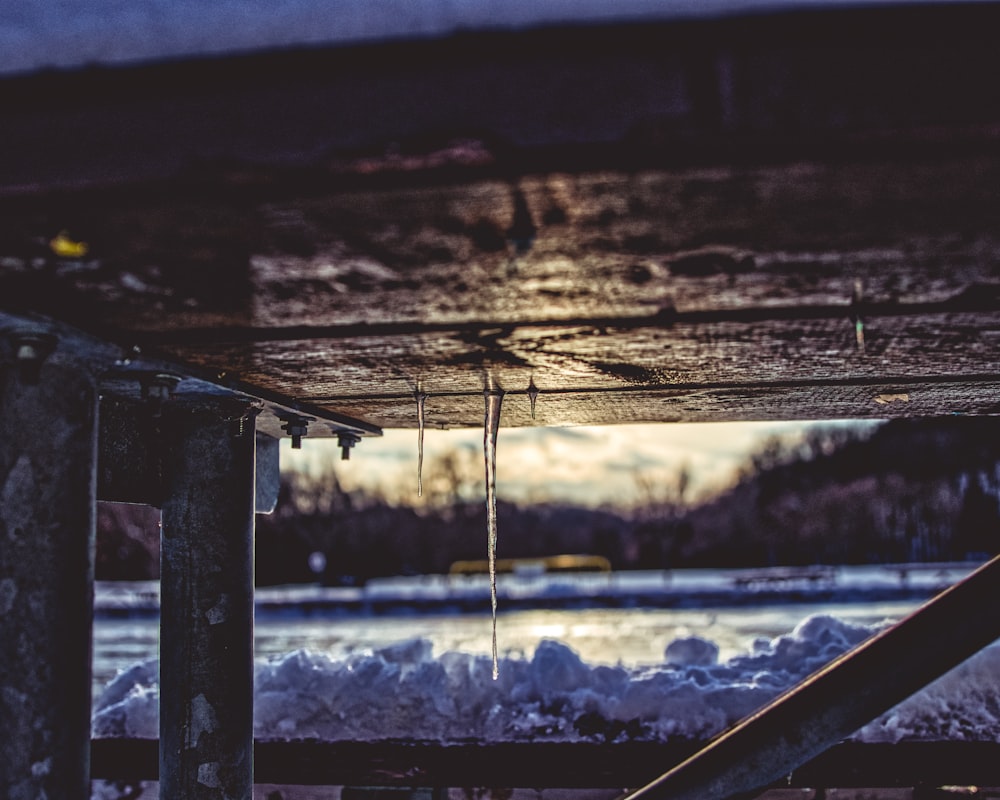 icicle beneath brown surface