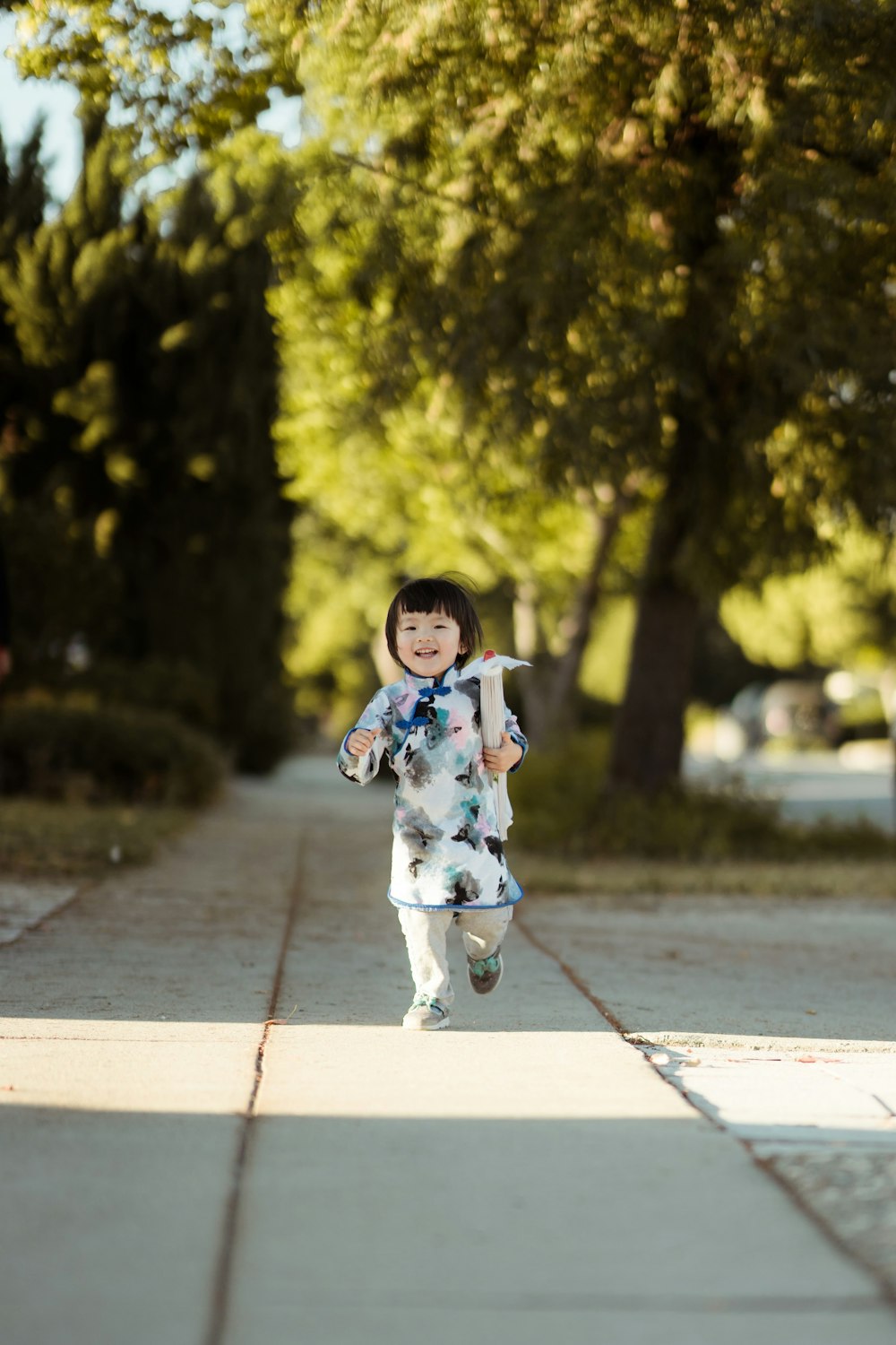 girl walks on gray concrete pathway