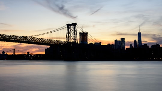 silhouette photograph of bridge and city buildings in Williamsburg Bridge United States