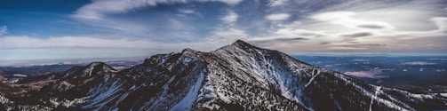 A panoramic view of mountains under a dramatic sky