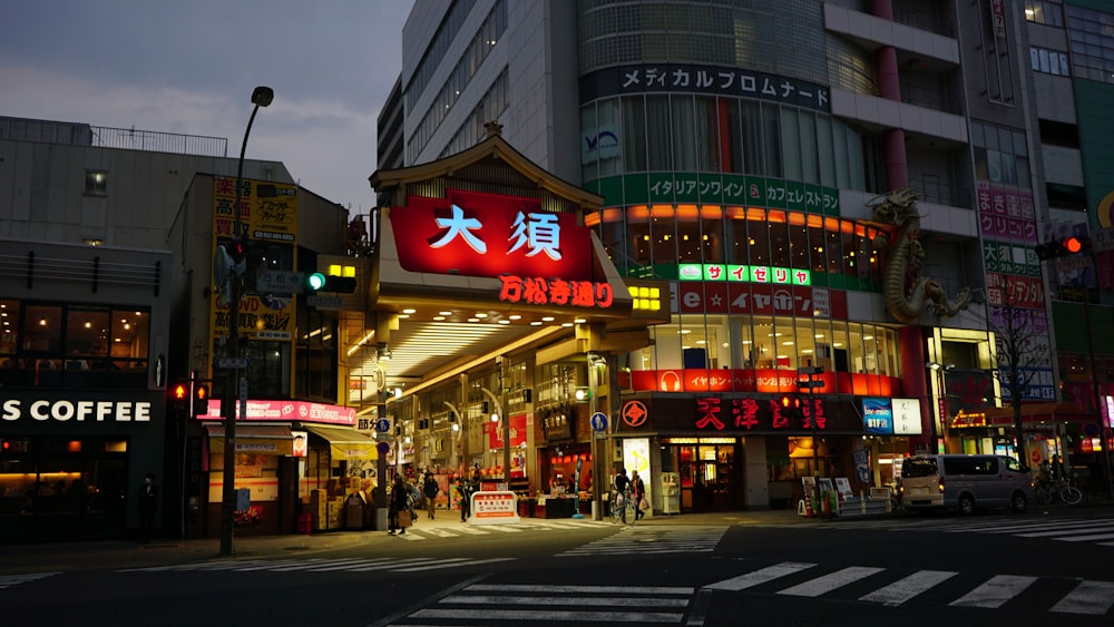 people passing through the lighted building