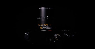 Close-up of a camera lens focused on a product for a sleek marketing shoot.