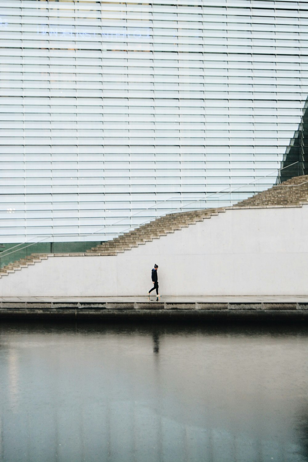 person walking beside concrete staircase