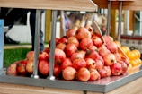 Bright red pomegranates arranged in baskets ready for distribution.