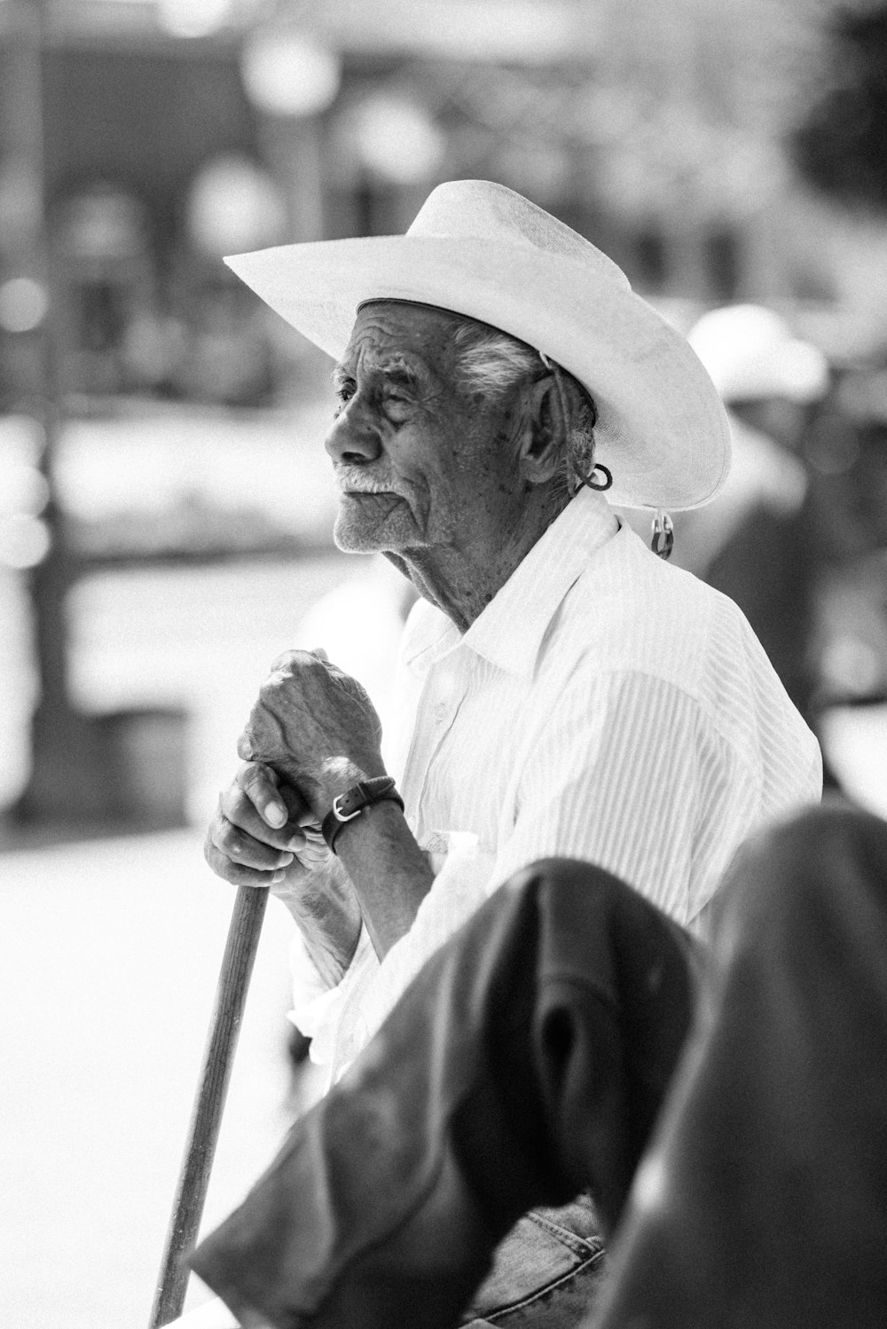 man in white dress shirt and black hat