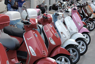 A lineup of special edition scooters, each styled with distinct themes like racing stripes, camouflage, and natural tones.