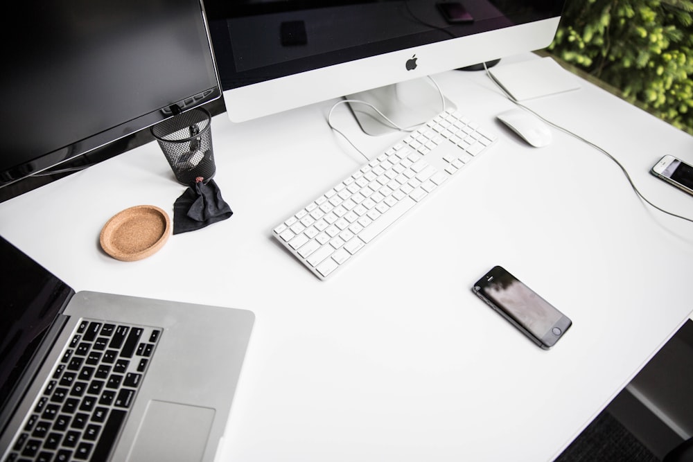 space gray iPhone 6 on table near magic keybord