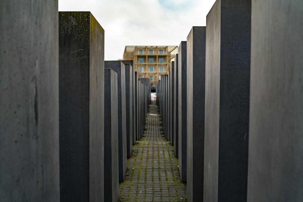 a narrow walkway between two concrete pillars