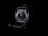 A vintage camera is prominently displayed against a dark background, showcasing its intricate mechanical details and lens at the center. The lighting highlights the contours and design of the camera, emphasizing its classic and historical appearance.