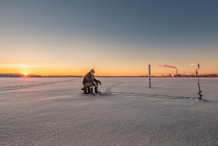 Angler with an ice auger