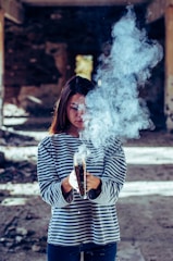 person holding book with smoke