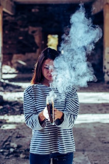 person holding book with smoke