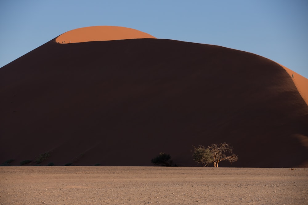 brown sand near mountain at daytime