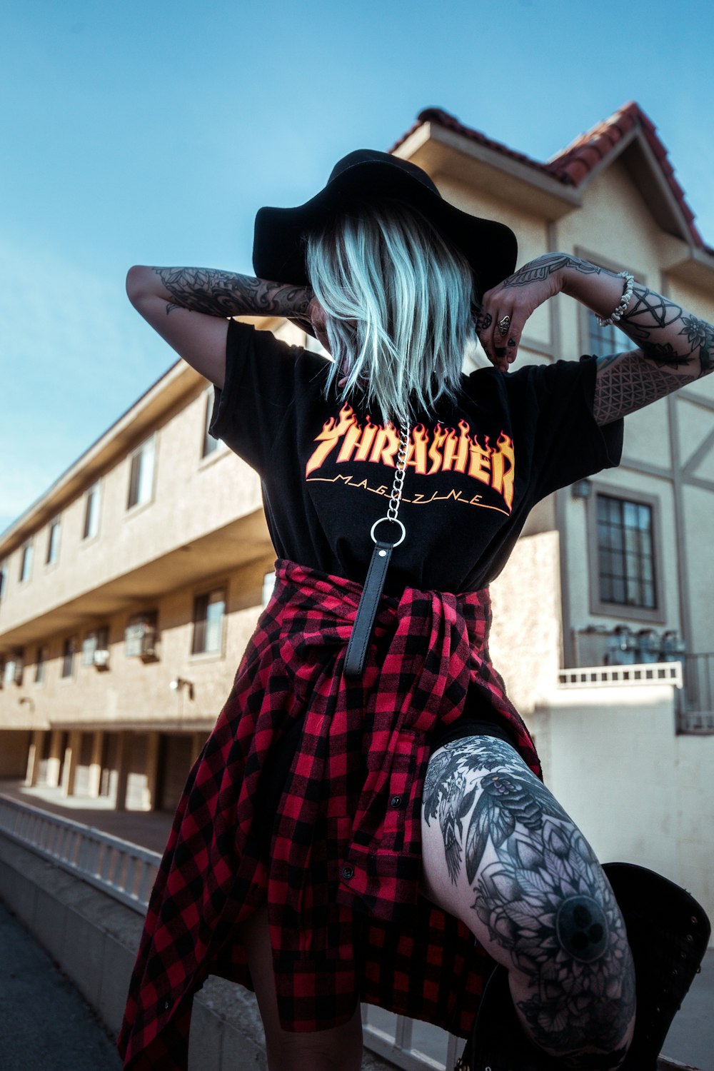 woman with tattoo standing on terrace