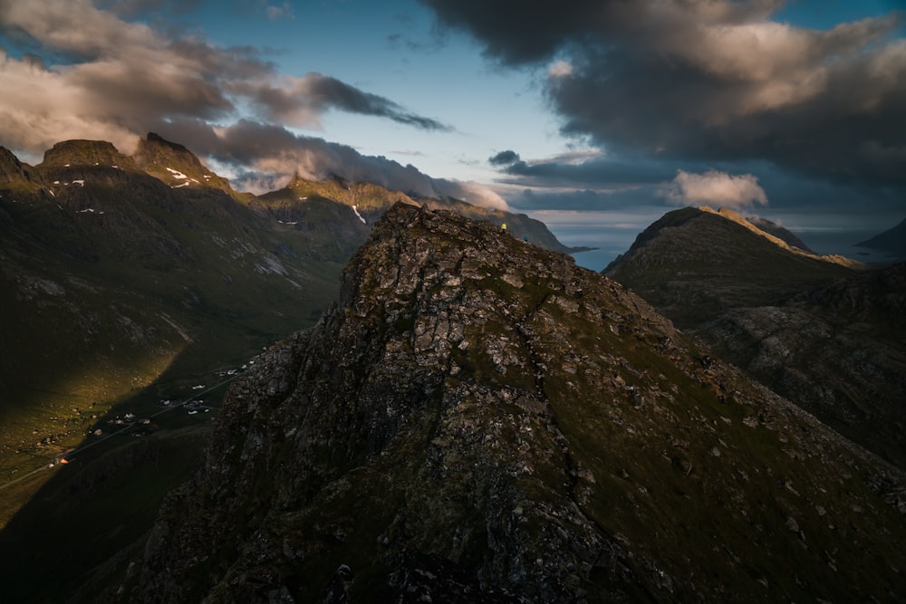 high angle photo of mountain range under cloudy sky