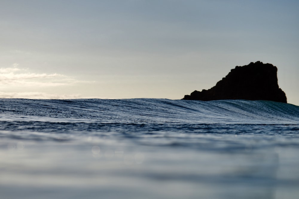 mountain cliff on body of water