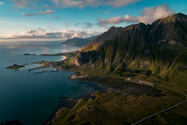 Buildings near body of water and rock formation — Lofoten, Norway