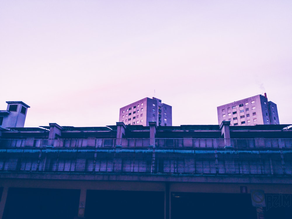 photo of high rise building under white cloud blue skies