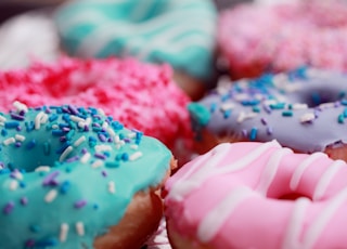 shallow focus photography of assorted doughnuts with sprinkles