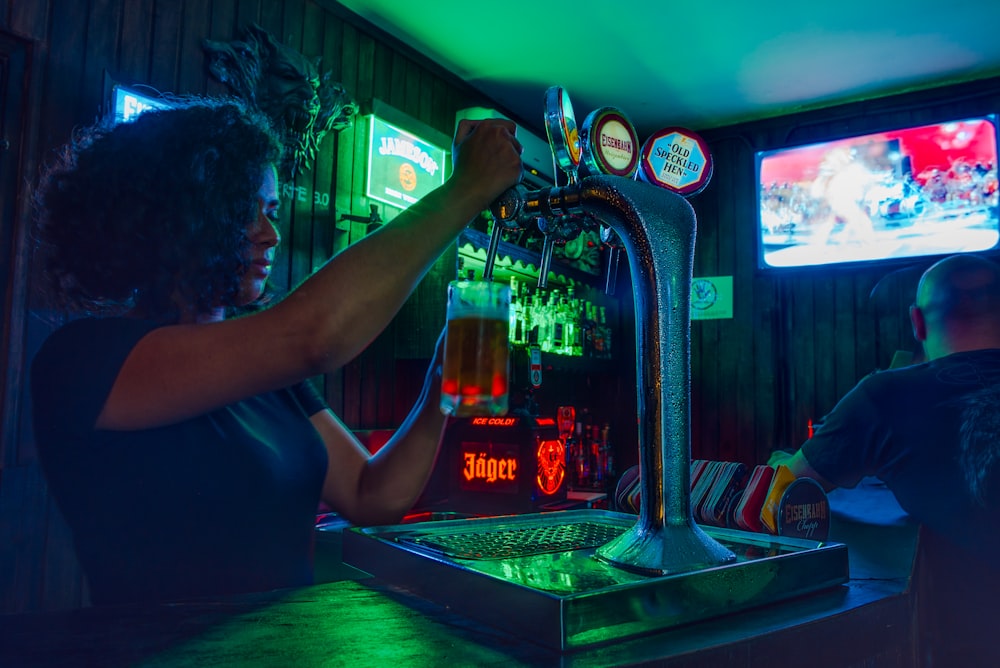 woman pouring beer from fountain