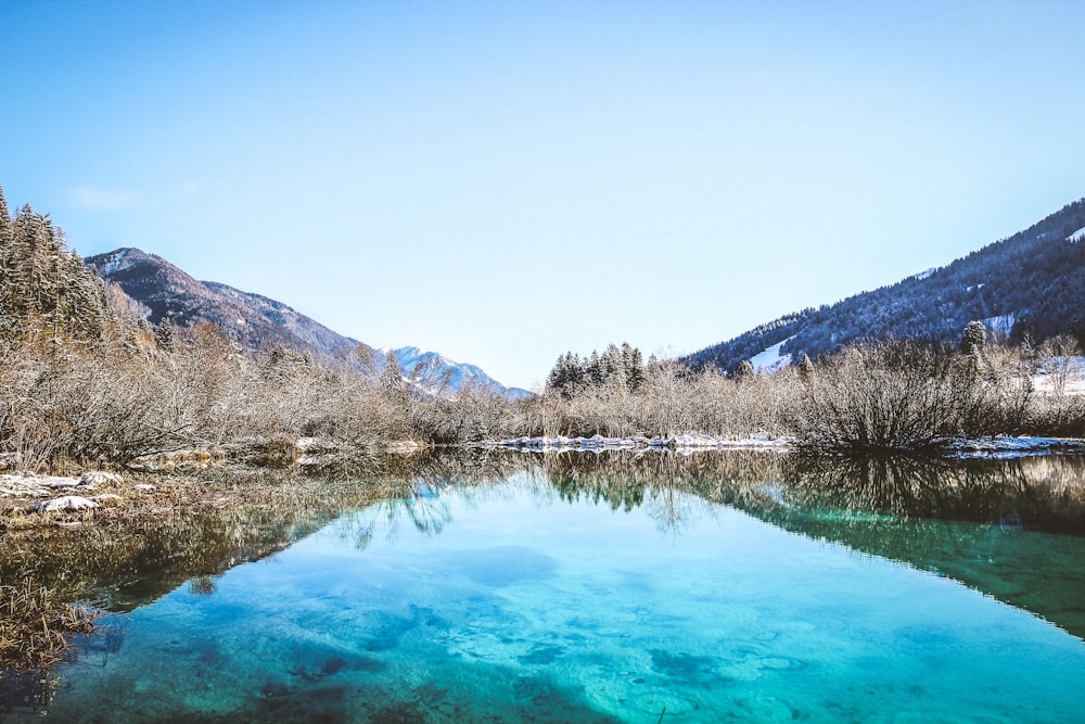 body of water surrounded by mountain range