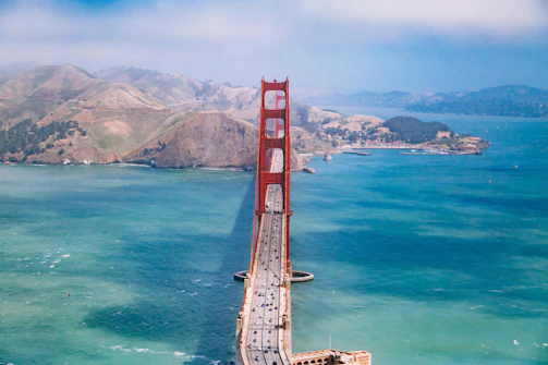 Golden Gate Bridge with a plane taking off in the background.