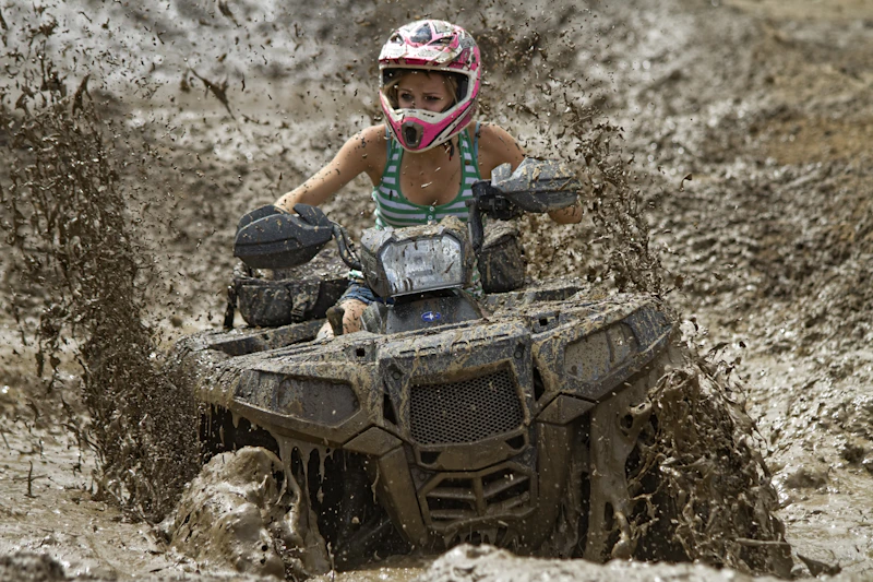 ATV rider moving through mud