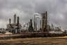 factories with smoke under cloudy sky