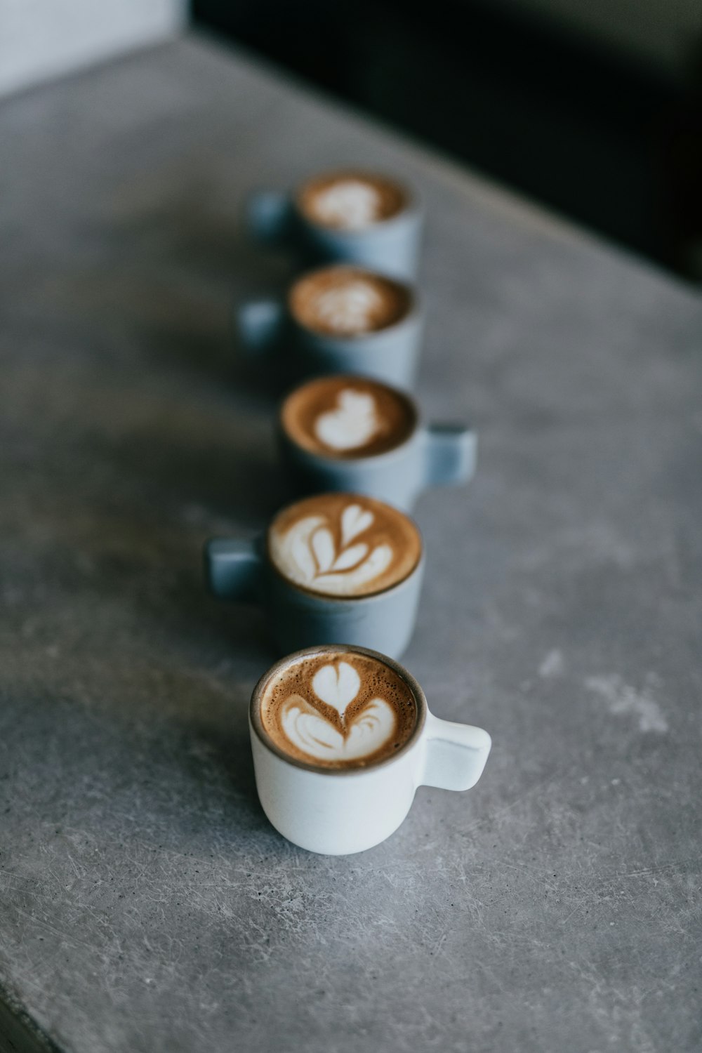 selective focus photography of white mug with latte forming heart