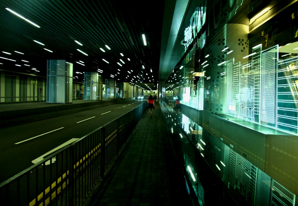 photo of woman walking on pavement