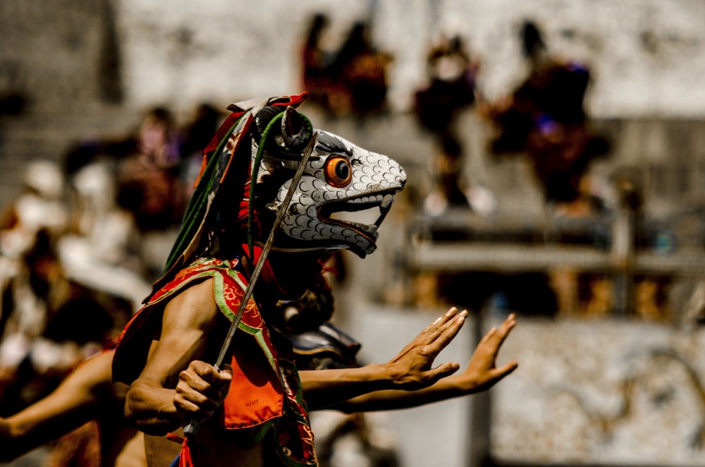 person standing holding machete selective focus photography