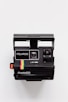 black Polaroid camera with white background