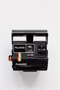 black Polaroid camera with white background