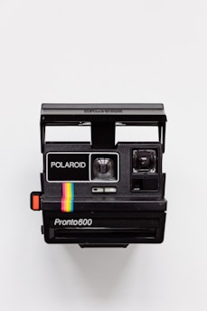 black Polaroid camera with white background