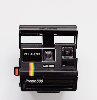 black Polaroid camera with white background