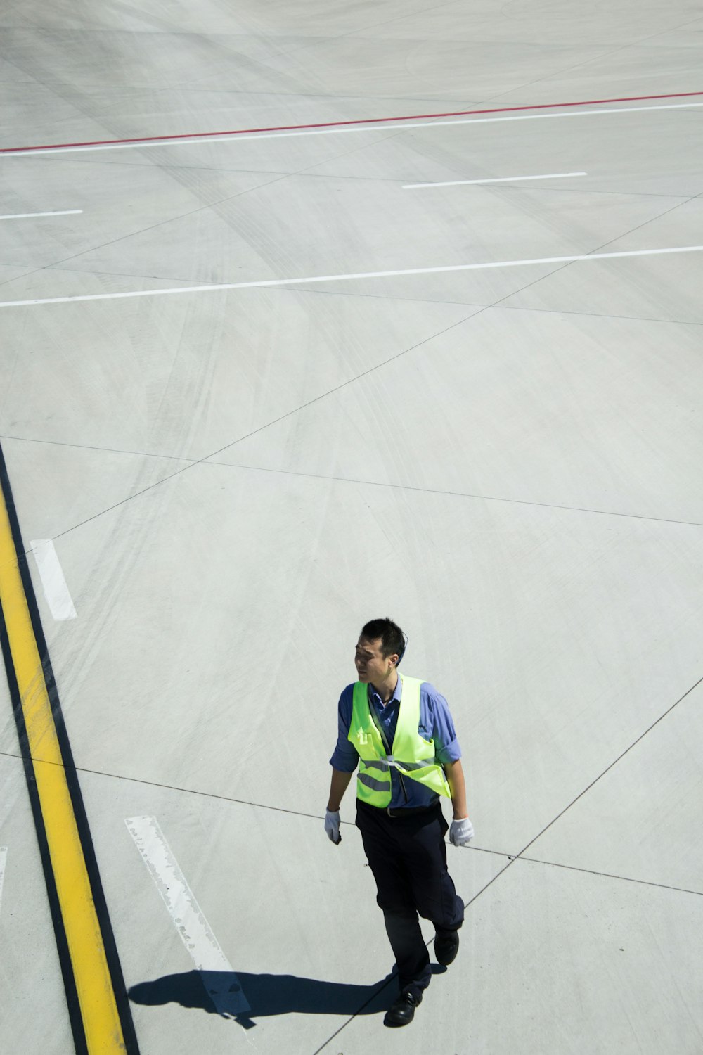 man walking on concrete pavement