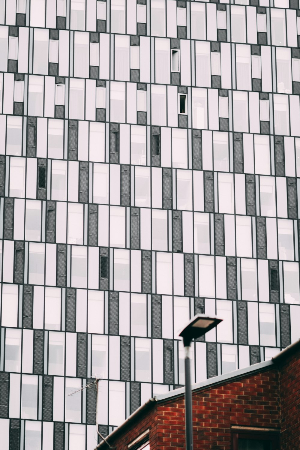 low angle photo of white and black high-rise building