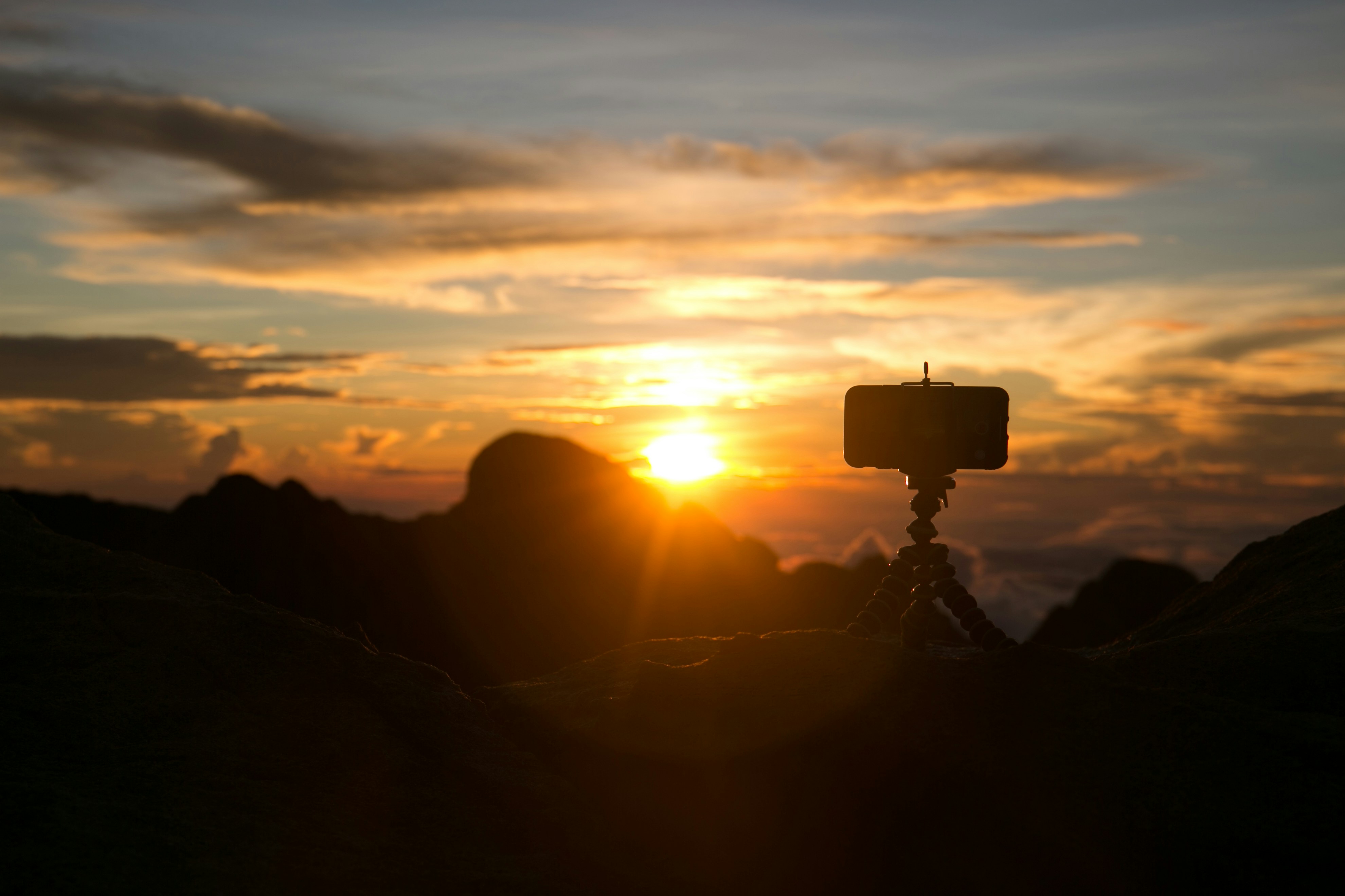 silhouette of camera with gorrila pod during sunset, 