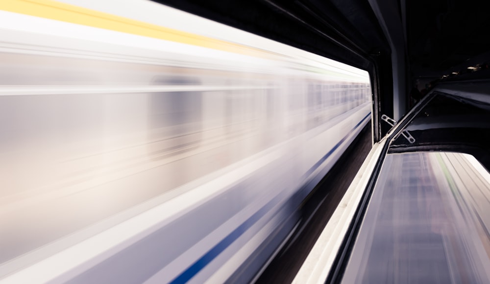 timelapse photo of white train and subway station