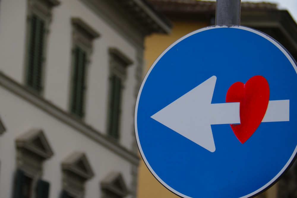 white arrow through red heart road signage