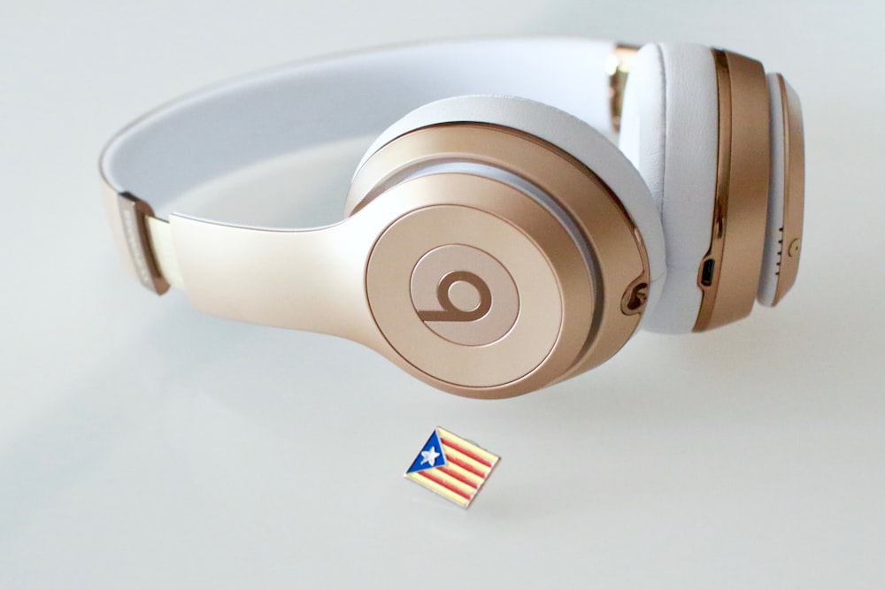 gold and white Beats headfphones