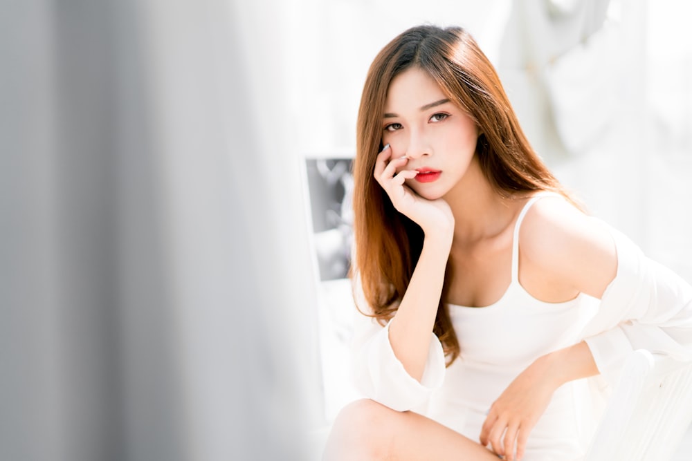 woman wearing lingerie sitting on bed