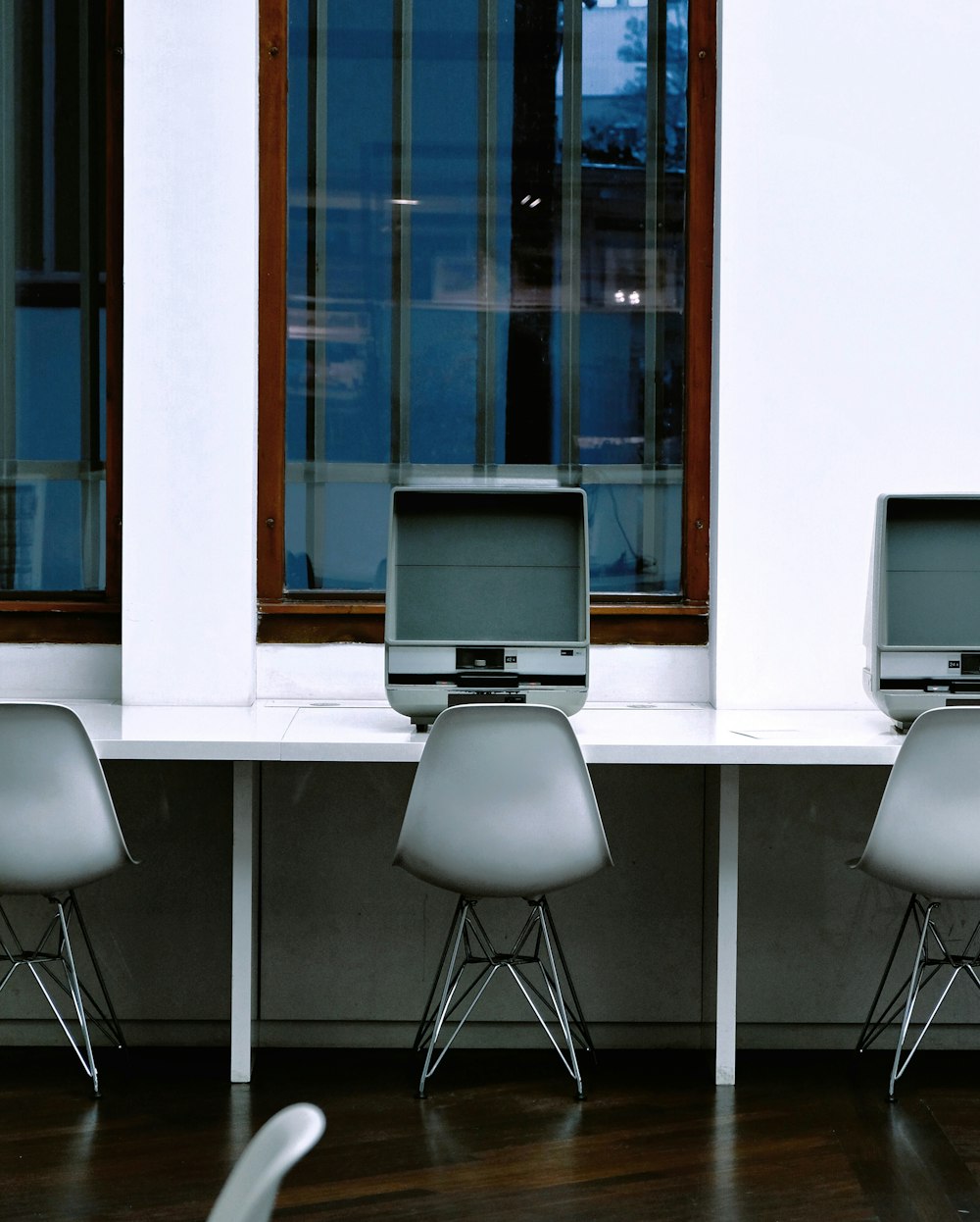 gray flat screen monitor on white wooden desk