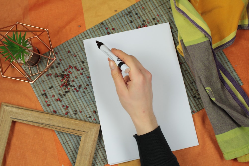 person holding black marker