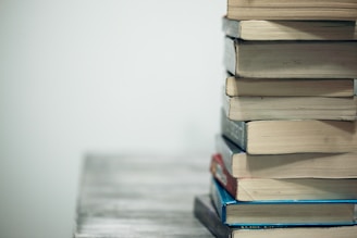 assorted books on wooden table