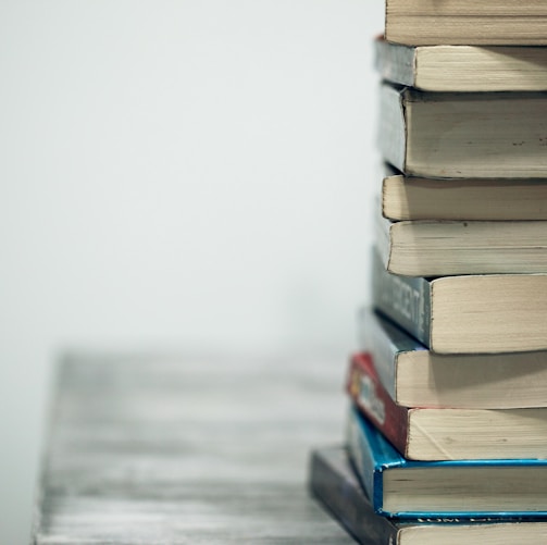 assorted books on wooden table