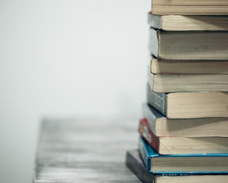 assorted books on wooden table