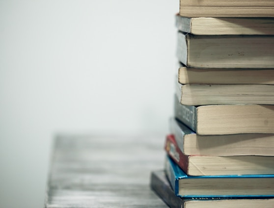 assorted books on wooden table