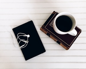 A quiet workspace with a cup of coffee and marketing books stacked neatly.