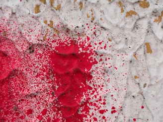 Abstract industrial textures in black and white with splashes of bright red paint.